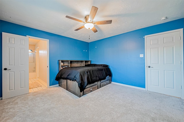 bedroom featuring ceiling fan, carpet flooring, baseboards, and a textured ceiling