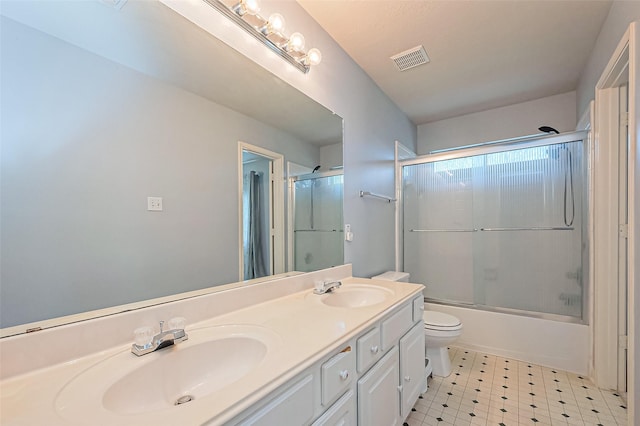 bathroom featuring a sink, visible vents, double vanity, and tile patterned floors