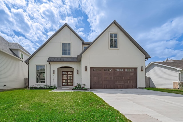 view of front of home featuring a front lawn, concrete driveway, metal roof, a garage, and a standing seam roof