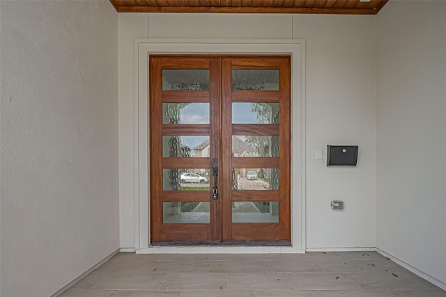 doorway to property featuring french doors and stucco siding