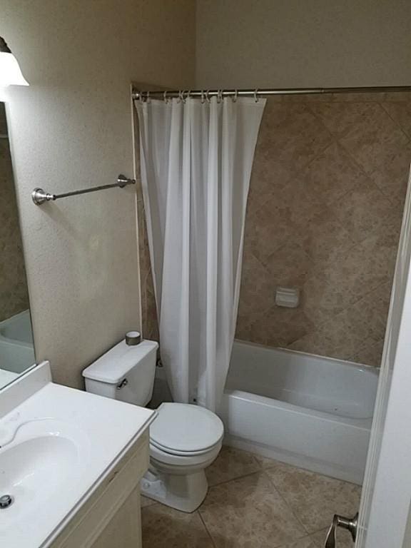 full bathroom featuring vanity, toilet, tile patterned flooring, and shower / tub combo with curtain