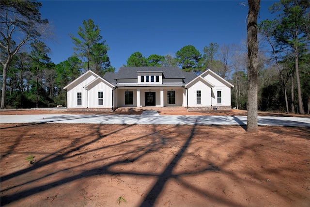 modern inspired farmhouse with concrete driveway