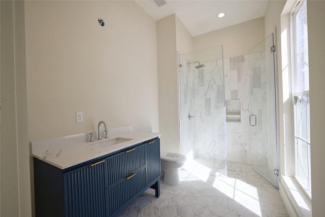 full bathroom with vanity, toilet, and a marble finish shower