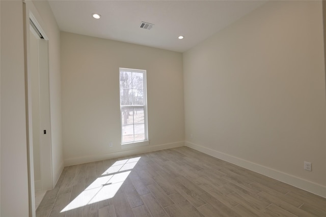 unfurnished bedroom featuring visible vents, multiple windows, and light wood-style floors