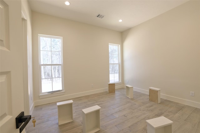 spare room featuring visible vents, recessed lighting, light wood-type flooring, and baseboards