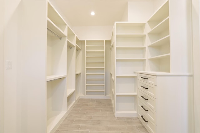 walk in closet featuring wood finish floors