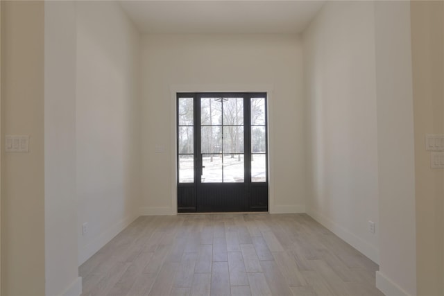 interior space with light wood-style flooring and baseboards