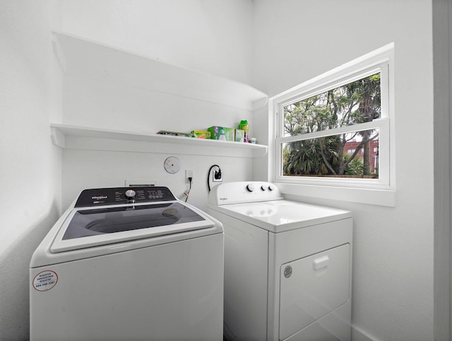 washroom featuring laundry area and separate washer and dryer