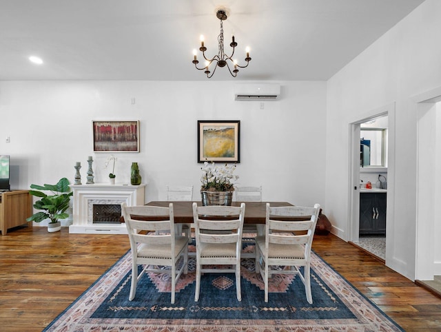 dining space featuring an inviting chandelier, an AC wall unit, recessed lighting, and wood finished floors