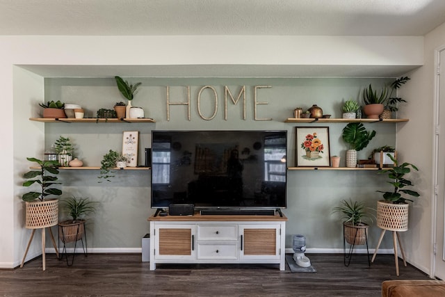 living area featuring dark wood-type flooring and baseboards