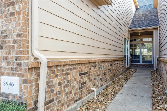 exterior space with roof with shingles