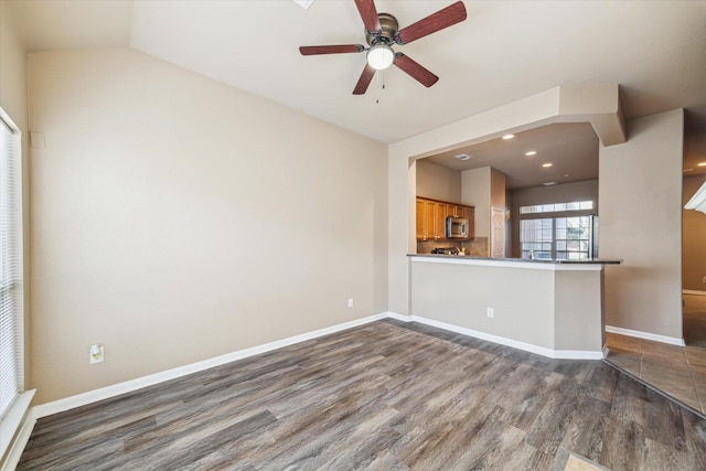 unfurnished living room with recessed lighting, baseboards, dark wood-style flooring, and ceiling fan