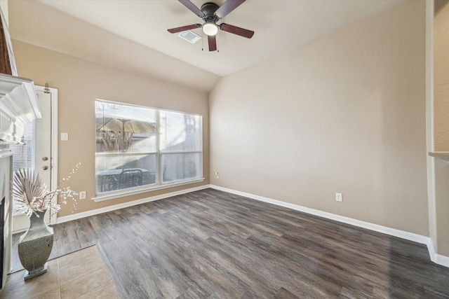 unfurnished living room featuring wood finished floors, baseboards, lofted ceiling, and ceiling fan