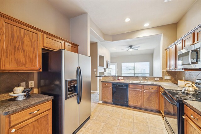 kitchen featuring light tile patterned floors, black appliances, brown cabinetry, and a ceiling fan