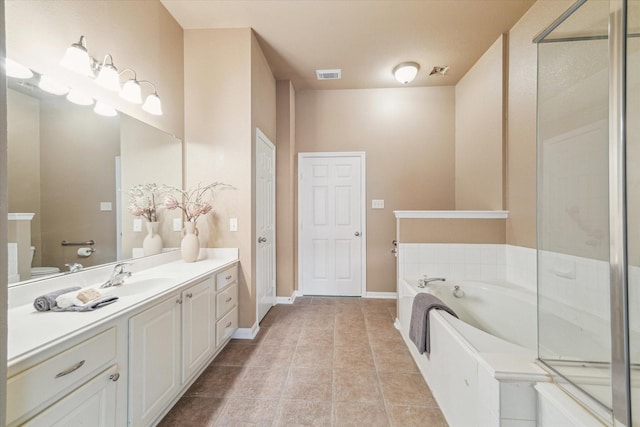 bathroom with vanity, visible vents, tile patterned flooring, a garden tub, and toilet