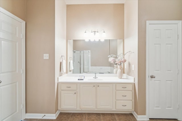 full bathroom featuring tile patterned flooring, a shower stall, vanity, and baseboards