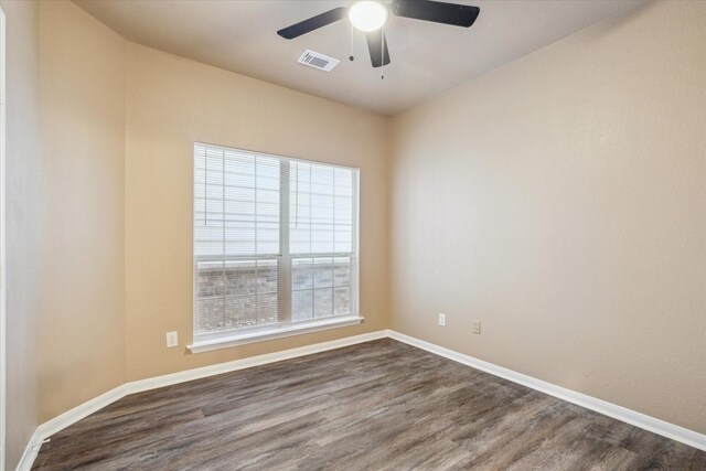 unfurnished room featuring visible vents, baseboards, ceiling fan, and dark wood-style flooring