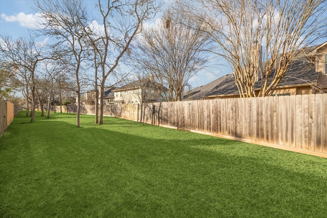 view of yard with a fenced backyard