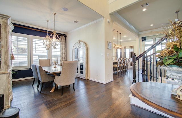 dining room with visible vents, baseboards, dark wood finished floors, ornamental molding, and an inviting chandelier