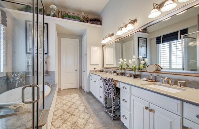 full bathroom with a sink, a stall shower, a tub, and double vanity