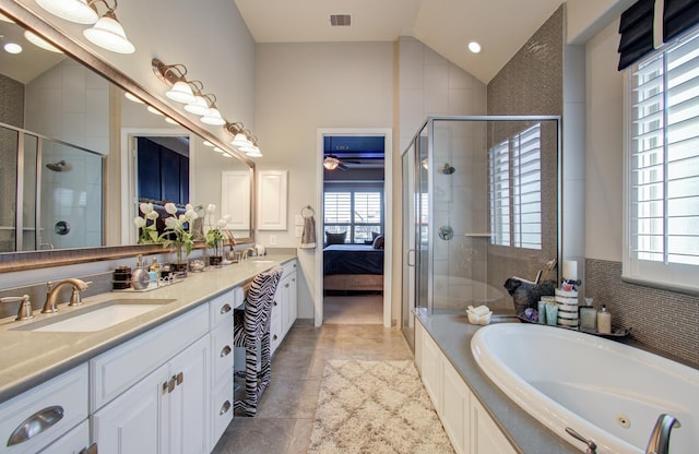 bathroom featuring vaulted ceiling, visible vents, a healthy amount of sunlight, and a sink