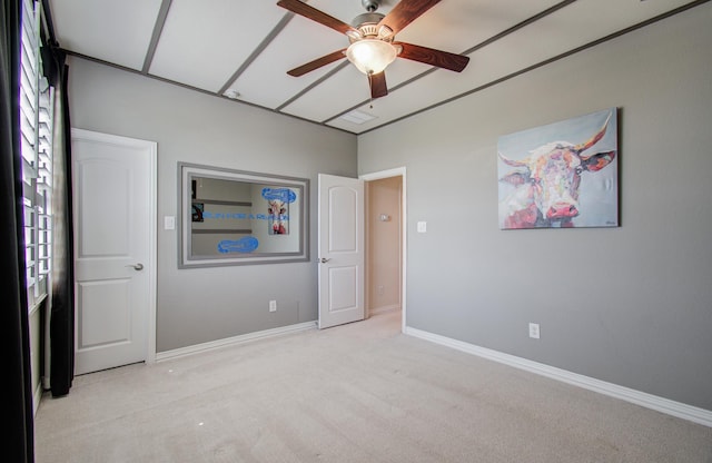 unfurnished bedroom featuring a ceiling fan, baseboards, and light carpet