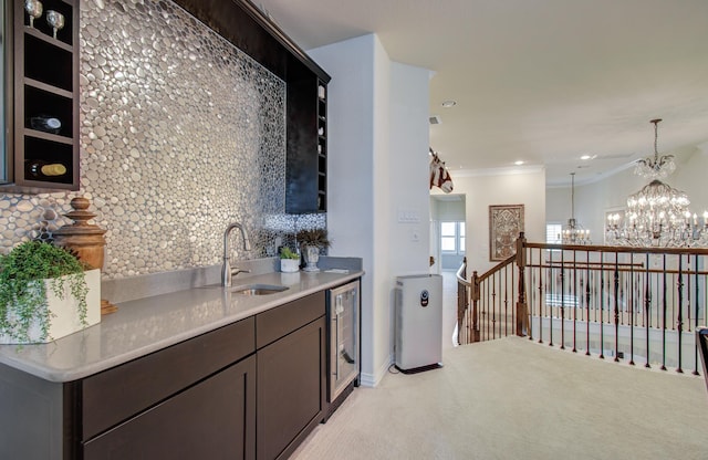 interior space featuring a sink, wine cooler, light carpet, crown molding, and a chandelier