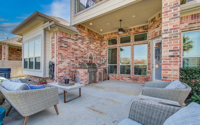 view of patio featuring outdoor lounge area, a balcony, an outdoor kitchen, and grilling area