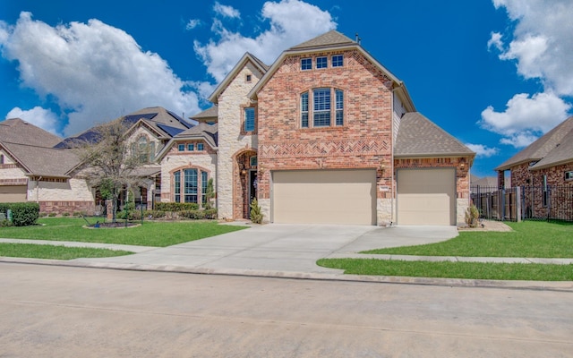 view of front of home featuring driveway, brick siding, a front yard, and fence