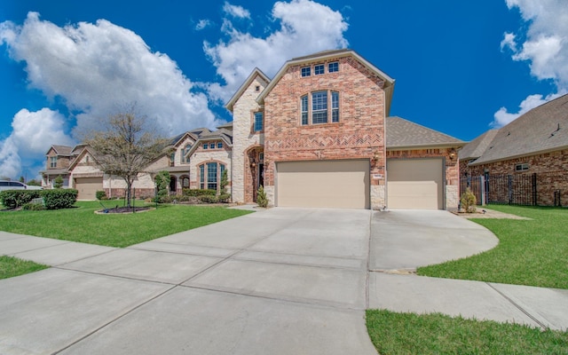 view of front of home featuring fence, driveway, a front lawn, a garage, and brick siding