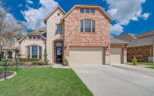 view of front of property with a front lawn, driveway, stone siding, an attached garage, and brick siding