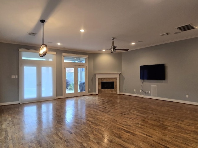 unfurnished living room featuring french doors, visible vents, wood finished floors, and a ceiling fan