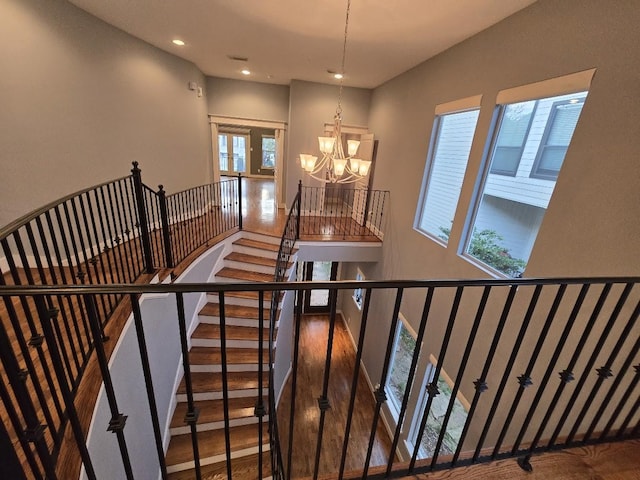 stairs with a notable chandelier and recessed lighting