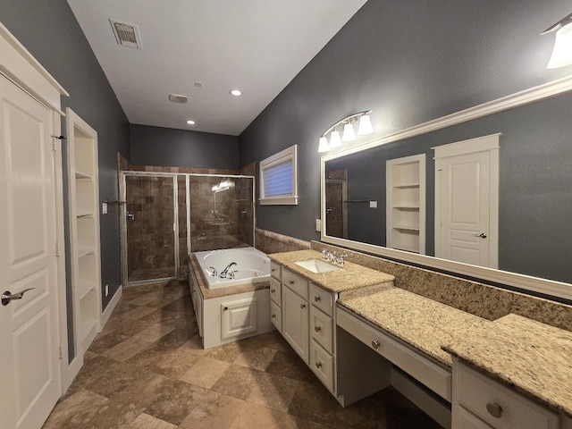 bathroom featuring visible vents, a closet, a shower stall, a bath, and vanity