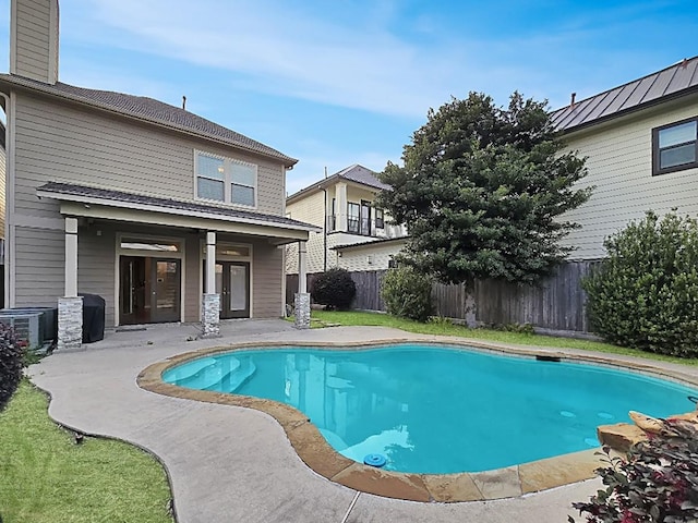 view of swimming pool featuring a fenced in pool, a patio area, and fence