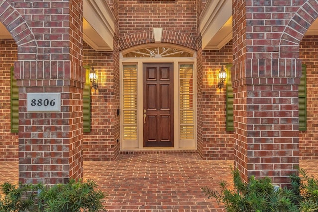 property entrance featuring brick siding