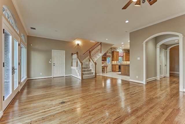 unfurnished living room featuring visible vents, light wood-style flooring, crown molding, and ceiling fan