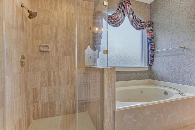 bathroom with a tub with jets, a stall shower, and wallpapered walls