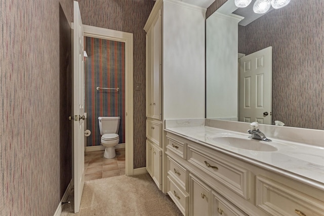 bathroom with toilet, wallpapered walls, tile patterned flooring, baseboards, and vanity