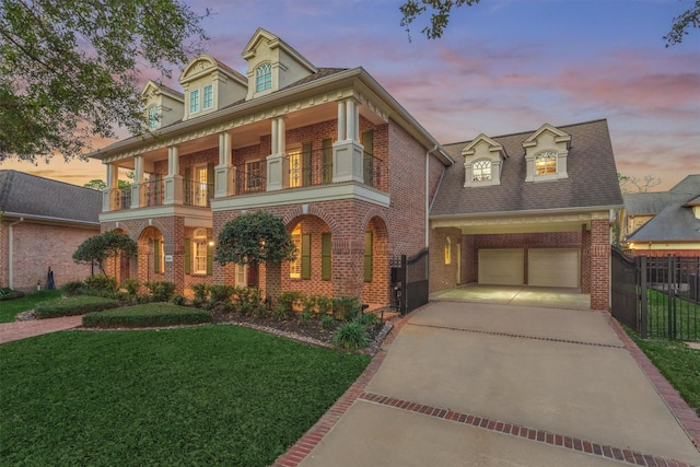 view of front of home with a balcony, fence, driveway, a garage, and brick siding