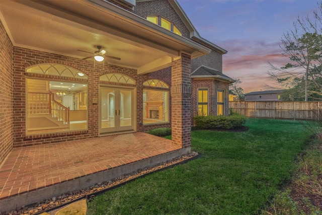 exterior space with french doors, a ceiling fan, and fence