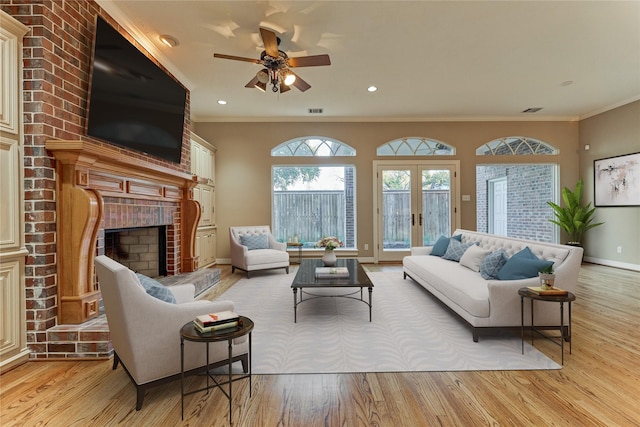 living room with a brick fireplace, wood finished floors, and ornamental molding