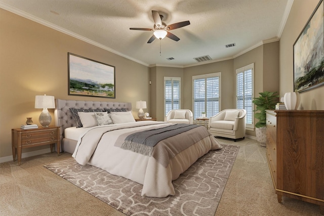 bedroom with visible vents, light colored carpet, crown molding, and baseboards