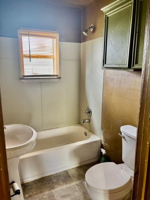 bathroom featuring toilet and shower / bathtub combination