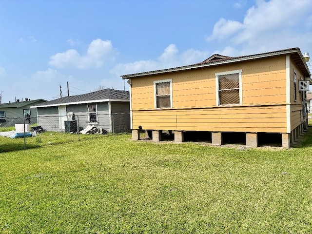 back of property featuring a yard, fence, and cooling unit