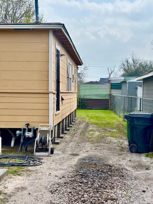 view of side of property featuring fence