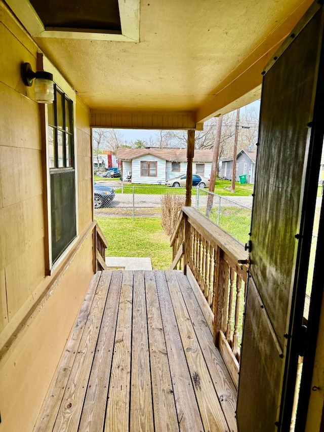 deck featuring a residential view and a lawn