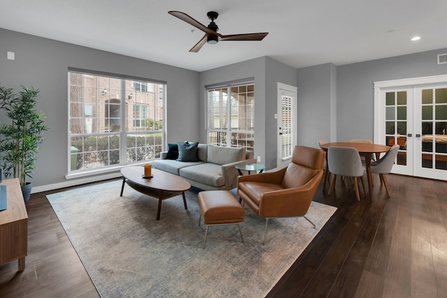 living room featuring visible vents, baseboards, ceiling fan, dark wood-type flooring, and french doors