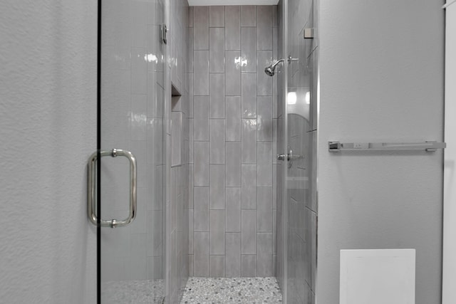 full bath featuring a shower stall