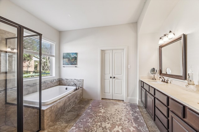 full bathroom with a stall shower, vanity, and a garden tub